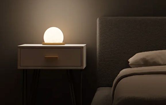 Настольный светильник Galaktika на тумбе у кровати